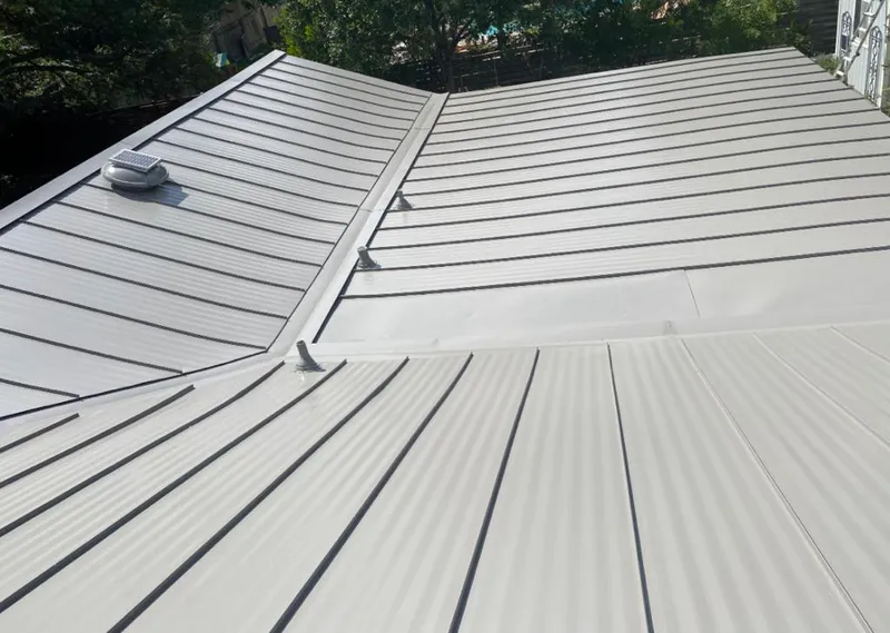 Solar attic fan installed on a metal roof for Roof Ventilation in Boynton Beach